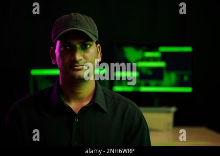 Portrait of hacker looking at camera after launching cyberattack Stock Photo