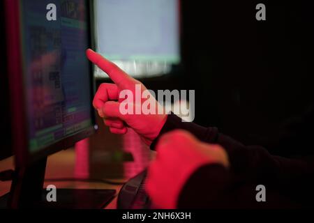 Closeup image of hackers pointing at computer screen, blockchain cyberattack concept Stock Photo