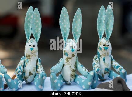 Embroidered soft toy hares made of material are great for a gift in a rabbit year, both for children and adults. A fascinating hobby Stock Photo