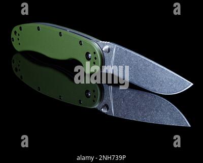 Edc folding knife with stonewash coated blade with reflection isolated on black background Stock Photo