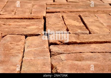 Pile of red bricks texture background selective focus Stock Photo