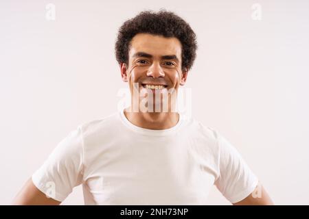 Studio shot portrait of happy smiling mixed race man. Stock Photo