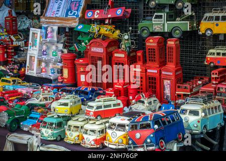 British souvenirs toys and objects with phone booths, vintage mini bus and cars at Portobello market in London, UK Stock Photo