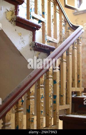 Destroyed staircase railing in an abandoned building. Stock Photo