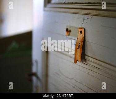 Torn sign at the door of an abandoned quarantine station, Iso (abbreviation for Isolation) is written on it. Stock Photo