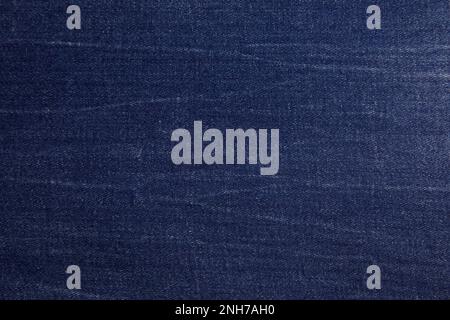 Dark blue jeans fabric background texture. Dark blue jeans fabric cloth textile material. Stock Photo