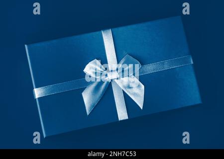Classic Blue color of the Year 2020. Gradient colors palette. Creative pattern box with bow on classic blue background. Holiday gift minimal concept. Stock Photo