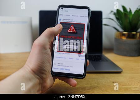 Virus warning notification on phone screen. Dangerous malware virus in phone Concept Stock Photo