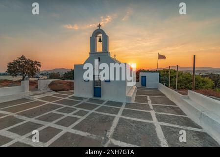 Sun rising behind the small chapel of Agios Nikolaos in Agia Anna village, Naxos Stock Photo