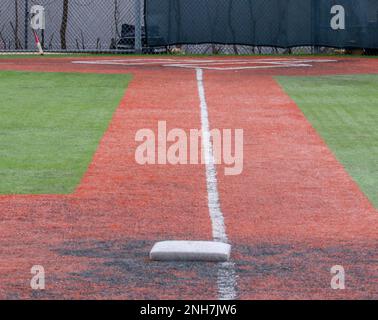 Looking at the foul line from third base to home plate on a turf baseball field. Stock Photo