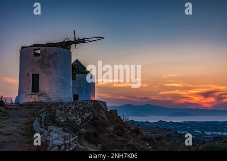 Traditional Cycladic windmills in Vivlos village at dusk, Naxos Stock Photo