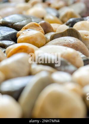 A pile of rocks displaying a variety of mineral colors. Stock Photo
