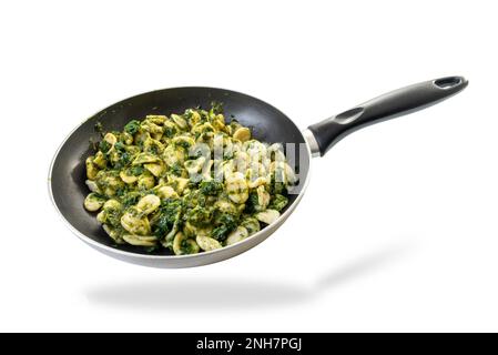 Orecchiette pasta with pan-fried turnip tops, typical Italian recipe from Puglia region in pan isolated on white with clipping path Stock Photo