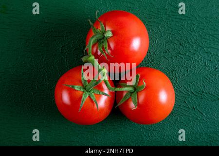 A group of grape tomatoes on a green background,top view Stock Photo