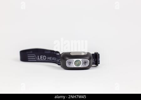 a flashlight on the head for illumination on a white background object Stock Photo