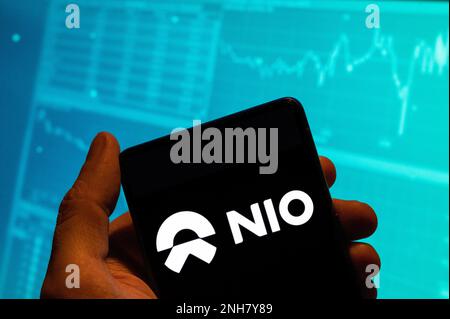 China. 15th Feb, 2023. In this photo illustration, the Chinese electric (EV) automobile manufacturer NIO logo is seen displayed on a smartphone with an economic stock exchange index graph in the background. Credit: SOPA Images Limited/Alamy Live News Stock Photo