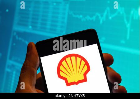 China. 15th Feb, 2023. In this photo illustration, the Anglo-Dutch global group of energy and petrochemical company Shell logo is seen displayed on a smartphone with an economic stock exchange index graph in the background. (Photo by Budrul Chukrut/SOPA Images/Sipa USA) Credit: Sipa USA/Alamy Live News Stock Photo