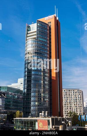 Vienna, Austria - October 17, 2022: Facade and sign of the office building of Unisyx in Andromeda Tower, modern skyscraper in Donau City or Vienna DC, Stock Photo
