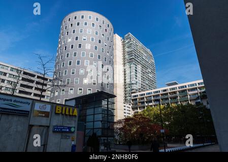 Vienna, Austria - October 17, 2022: Street with people around and residential and office modern buildings in Donau City or Vienna DC, Vienna, Austria Stock Photo