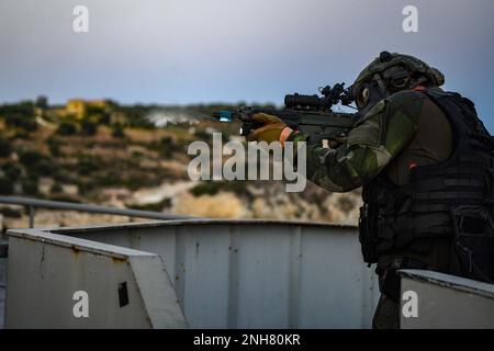 NAVAL SUPPORT ACTIVITY SOUDA BAY, Greece (July 21, 2022) – A Swedish Marine with 4th Marine Regiment, Swedish Amphibious Corps fires simulated rounds during exercise TYR 22 at the NATO Maritime Interdiction Operational Training Centre (NMIOTC) in Souda Bay, Greece, July 21, 2022. TYR 22 is a maritime interdiction operations exercise held at NMIOTC, bringing together Swedish Marines, U.S. Marines, U.S. Navy Special warfare combatant-craft crewmen to improve US and NATO Partner operational capacity, capability, and interoperability. Stock Photo