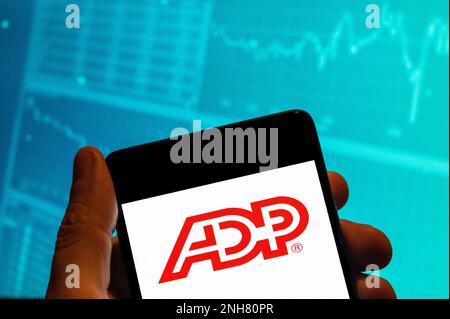China. 15th Feb, 2023. In this photo illustration, the American provider of human resources management software and services company, Automatic Data Processing (ADP) logo is seen displayed on a smartphone with an economic stock exchange index graph in the background. (Credit Image: © Budrul Chukrut/SOPA Images via ZUMA Press Wire) EDITORIAL USAGE ONLY! Not for Commercial USAGE! Stock Photo