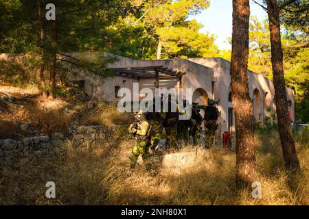 NAVAL SUPPORT ACTIVITY SOUDA BAY, Greece (July 21, 2022) – Swedish Marines with 4th Marine Regiment, Swedish Amphibious Corps conduct a raid training exercise during TYR 22 at the NATO Maritime Interdiction Operational Training Centre (NMIOTC) in Souda Bay, Greece, July 21, 2022. TYR 22 is a maritime interdiction operations exercise held at NMIOTC, bringing together Swedish Marines, U.S. Marines, U.S. Navy Special warfare combatant-craft crewmen to improve US and NATO Partner operational capacity, capability, and interoperability. Stock Photo