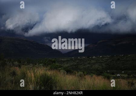 Storm clouds gather over an African village as extreme weather afflicts parts of south eastern Africa Stock Photo