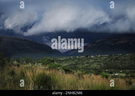 Storm clouds gather over an African village as extreme weather afflicts parts of south eastern Africa Stock Photo