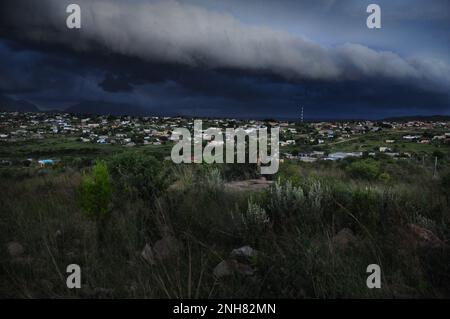 Storm clouds gather over an African village as extreme weather afflicts parts of south eastern Africa Stock Photo