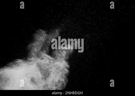 White powder explosion isolated on black background.White dust particles splash. Stock Photo