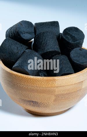 Helsinki / Finland - FEBRUARY 21, 2023 - Traditional Finnish cuisine: A bowl of sweet black licorice against a white background Stock Photo