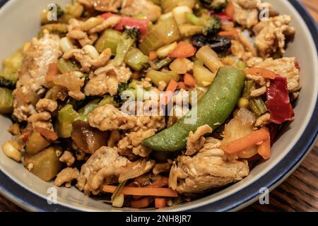 Ground turkey stir-fry over jasmine rice in a bowl at a table in Taylors Falls, Minnesota USA. Stock Photo