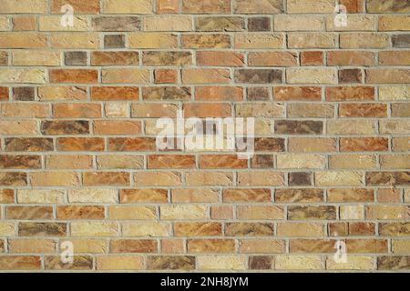 Brown clinker brick wall building. Old style brick wall texture background. Grunge dirty old rusty wall. Yellow and red bricks. Bright wall high resol Stock Photo