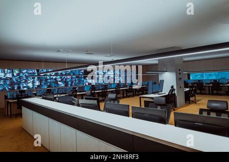 Empty interior of big modern security system control room, workstation with multiple displays, monitoring room with at security data center Empty Stock Photo
