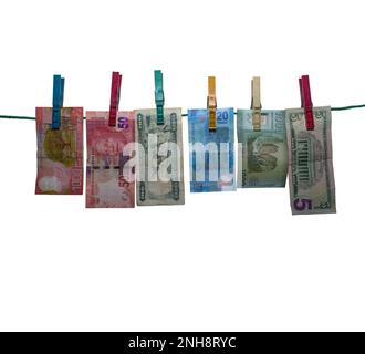 Six banknotes after money laundering to dry on a clothesline, isolated, white background Stock Photo