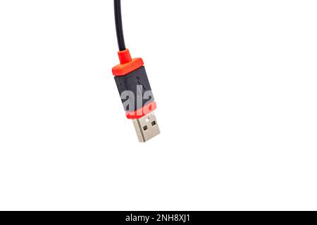 A USB plug type A in red and black cropped against white background as studio shot Stock Photo