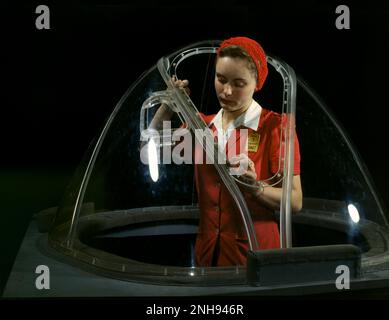 Woman working on the bombardier nose section of a B-17F navy bomber, at the Douglas Aircraft Company plant in Long Beach, California, October 1942. Photo by Alfred T. Palmer./n Stock Photo