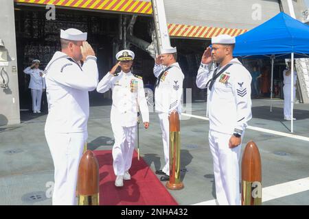 220728-N-ZS023-1010 SAN DIEGO (July 28, 2022) Cmdr. Michael Piano, commanding officer of Independence-variant littoral combat ship USS Gabrielle Giffords (LCS 10) Blue Crew, salutes sideboys upon arrival during a change of command ceremony. LCS are fast, agile, mission-focused platforms designed to operate in near-shore environments, winning against 21st-century coastal threats. LCS are capable of supporting forward-presence, maritime security, sea control, and deterrence missions around the globe. Stock Photo