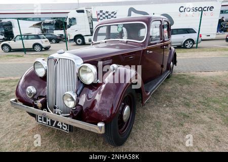 Three-quarters Front View of a 1937, Maroon, Rover 16, parked in front of the Wing, at the 2022 Silverstone Classic Stock Photo