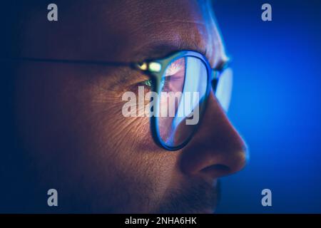 Focused on Computer Display Caucasian Entrepreneur in Glasses Close Up Photo. Stock Photo