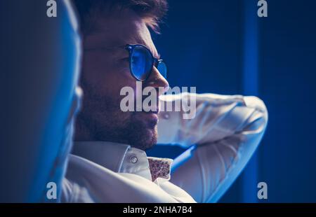 Relaxed and Successful Caucasian Business Owner Focused on a Data Displayed on a Screen. Business Theme. Stock Photo