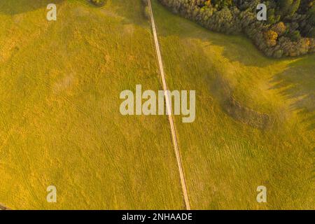 Drone photography of rural road going through farmlands during summer evening Stock Photo
