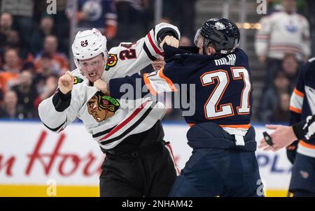 Seattle Kraken's Vince Dunn (29) controls the puck under pressure from  Chicago Blackhawks' Sam Lafferty (24) and Colin Blackwell during the first  period of an NHL hockey game Saturday, Jan. 14, 2023