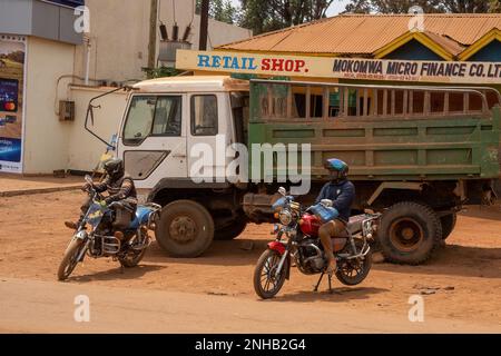 Karatu, Tanzania - October 16th, 2022: Two motorcycle cab drivers waiting for passengers on a Karatu, Tanzania, street, on a sunny day. Stock Photo