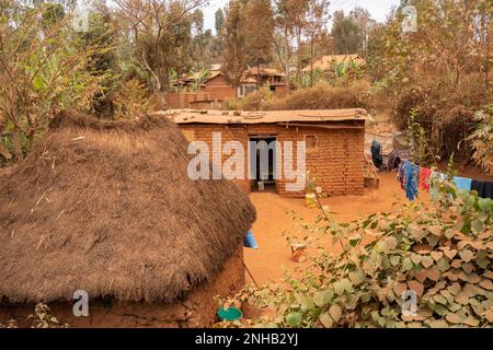 Karatu, Tanzania - October 16th, 2022: Traditional hutS made of mud, branches and straw and of mud bricks, in suburban Karatu, Tanzania. Stock Photo