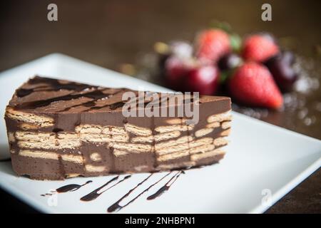 delicious piece of homemade chocolate cake with cookies Stock Photo