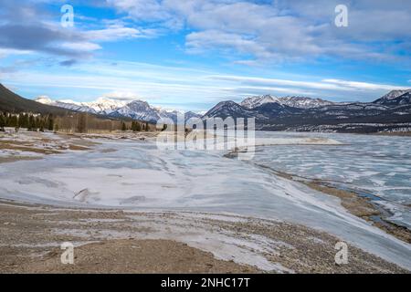 Abraham lake landscape in winter season with wave of snow on bluish ice Stock Photo