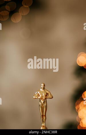 Hollywood gold oscars trophy figurine imitation seen during an award cinema ceremony. Success and victory concept close up statuette at twinkle yellow Stock Photo