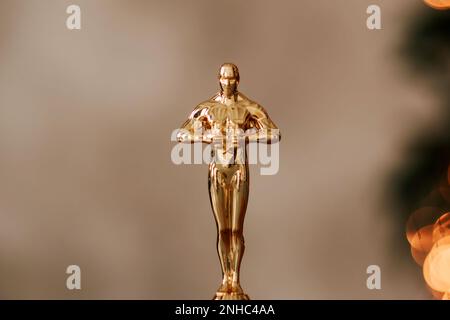 Hollywood gold oscars trophy figurine imitation seen during an award cinema ceremony. Success and victory concept close up statuette at twinkle yellow Stock Photo