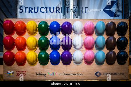 London, UK, Sept 2022, view of rows of colorful helmets at a construction site by Golden Square, Soho Stock Photo